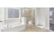 Bright bathroom with soaking tub, glass shower, and tile surround at 355 Miramar Dr, York, SC 29745
