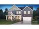 Charming two-story home featuring stone accents, a welcoming front porch, and manicured landscaping at 355 Miramar Dr, York, SC 29745