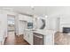 Bright kitchen features white cabinets, stainless steel appliances, quartz countertops and pendant lighting at 355 Miramar Dr, York, SC 29745