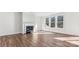 Sun-filled living room featuring a cozy fireplace, large windows, and gorgeous hardwood flooring at 355 Miramar Dr, York, SC 29745