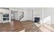 Open-concept space featuring hardwood floors, a fireplace, staircase, and access to the kitchen at 355 Miramar Dr, York, SC 29745