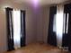 Bedroom with hardwood floors and black and white curtains at 401 Gillscreek Dr, Lancaster, SC 29720