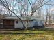 Ranch home with green metal roof, nestled in a wooded area at 401 Gillscreek Dr, Lancaster, SC 29720