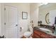 Powder room with granite vanity and dark wood cabinet at 4915 Magglucci Pl, Mint Hill, NC 28227