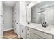 Modern bathroom featuring dual sinks, white cabinetry, and decorative mirrors at 5108 Verona Rd # 94, Charlotte, NC 28213