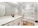 This bathroom features wooden floors, double vanity, a mirror, and a shower-tub combo at 5108 Verona Rd # 94, Charlotte, NC 28213