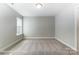 This bedroom features neutral walls, carpet flooring, and a window at 5108 Verona Rd # 94, Charlotte, NC 28213