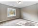 This bedroom features neutral walls, carpet flooring, and an abundance of natural light at 5108 Verona Rd # 94, Charlotte, NC 28213