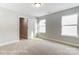 This bedroom features neutral walls, carpet flooring, and two doors at 5108 Verona Rd # 94, Charlotte, NC 28213