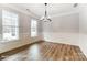 Elegant dining room with wainscoting, wood floors, and a modern chandelier at 5108 Verona Rd # 94, Charlotte, NC 28213