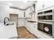 Modern kitchen featuring white cabinets, stylish backsplash, and stainless steel appliances at 5108 Verona Rd # 94, Charlotte, NC 28213