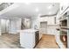 Open kitchen with a large island, white cabinets, and wood floors at 5108 Verona Rd # 94, Charlotte, NC 28213