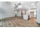 Open-concept living area featuring hardwood floors, modern lighting, and a spacious layout at 5108 Verona Rd # 94, Charlotte, NC 28213