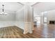 Spacious open-concept living room with wood floors, fireplace, and dining area at 5108 Verona Rd # 94, Charlotte, NC 28213
