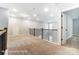 Bright loft area with neutral carpeting, railing, and a door to the adjacent room at 5108 Verona Rd # 94, Charlotte, NC 28213