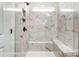 Luxurious walk-in shower with marble tile, built-in bench, and rain shower head at 5108 Verona Rd # 94, Charlotte, NC 28213