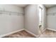 Functional walk-in closet with metal shelving and doorway to bathroom at 5108 Verona Rd # 94, Charlotte, NC 28213