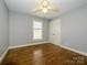 Spacious bedroom with hardwood floors and ceiling fan at 521 Mountainview Dr, Charlotte, NC 28270