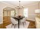 Bright dining room features hardwood floors, chandelier, and a table with seating for four at 521 Mountainview Dr, Charlotte, NC 28270