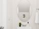 Stylish powder room with a vessel sink, round mirror, and modern fixtures at 5219 Reedy Ridge Rd, Charlotte, NC 28215