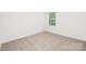 Sunlit bedroom features carpet and a view to the outdoors at 5219 Reedy Ridge Rd, Charlotte, NC 28215