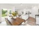 Bright dining area open to a modern kitchen with a large island and stainless steel appliances at 5219 Reedy Ridge Rd, Charlotte, NC 28215