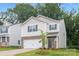 Charming home with stone accents, a two-car garage, and a well-manicured lawn at 5219 Reedy Ridge Rd, Charlotte, NC 28215