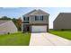 Two-story home featuring stone accents, a two-car garage, and a well-manicured lawn at 5219 Reedy Ridge Rd, Charlotte, NC 28215