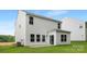 Back exterior view showcasing vinyl siding, windows, and a sliding glass door to the backyard at 5219 Reedy Ridge Rd, Charlotte, NC 28215