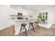 Modern kitchen featuring white cabinets, stainless steel appliances, and an island with bar seating at 5219 Reedy Ridge Rd, Charlotte, NC 28215