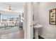 Small powder room with pedestal sink and oval mirror at 5219 Reedy Ridge Rd, Charlotte, NC 28215