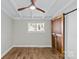 Simple bedroom with hardwood floors, barn door and neutral wall color at 5426 Milford Rd, Charlotte, NC 28210