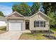 Charming single-story home with a well-manicured front yard and attached garage at 5615 Howard St, Charlotte, NC 28269