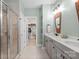 Bathroom boasts a walk-in shower and a double vanity with grey cabinets and a view into the closet at 6289 Raven Rock Dr, Denver, NC 28037