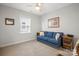 Bedroom with neutral carpet, natural light, and a comfortable blue sofa at 6289 Raven Rock Dr, Denver, NC 28037