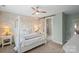 Calming bedroom featuring a four-poster bed, decorative brick accent wall and an ensuite bath at 6289 Raven Rock Dr, Denver, NC 28037