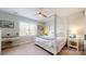 Calming bedroom featuring a four-poster bed, decorative brick accent wall and a light filled window at 6289 Raven Rock Dr, Denver, NC 28037