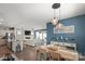 Open concept dining area with modern light fixtures and stylish decor next to a large living room at 6289 Raven Rock Dr, Denver, NC 28037