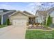 Charming single-story home boasts a two-car garage, manicured lawn, and tasteful landscaping at 6289 Raven Rock Dr, Denver, NC 28037