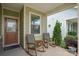 Cozy front porch with rocking chairs, a stylish front door, and ample natural light at 6289 Raven Rock Dr, Denver, NC 28037