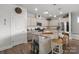 Open kitchen with granite countertops, stainless steel appliances, an island with bar seating, and ample cabinet space at 6289 Raven Rock Dr, Denver, NC 28037