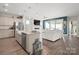 Stylish kitchen with a granite island, stainless steel appliances, and open layout into a large living room at 6289 Raven Rock Dr, Denver, NC 28037