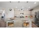 Bright kitchen with stainless steel appliances, granite island, and bar seating with elegant pendant lighting at 6289 Raven Rock Dr, Denver, NC 28037
