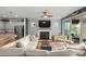 Bright living room with a fireplace, large windows, and a seamless flow to the kitchen and outdoor area at 6289 Raven Rock Dr, Denver, NC 28037
