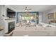 Comfortable living room with a fireplace, access to an outdoor patio, and stylish seating arrangements at 6289 Raven Rock Dr, Denver, NC 28037