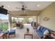 Inviting covered patio with ample seating, ceiling fan, and outdoor cooking area overlooking the lovely backyard at 6289 Raven Rock Dr, Denver, NC 28037
