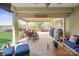 Inviting covered patio with ample seating and outdoor cooking area overlooking a manicured backyard at 6289 Raven Rock Dr, Denver, NC 28037