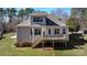 Rear view of the house featuring a wooden deck, multiple windows, and access to the backyard at 704 Kenway Loop, Mooresville, NC 28117