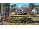 Spacious backyard with mature trees and a wooden deck, perfect for outdoor entertaining and relaxation at 704 Kenway Loop, Mooresville, NC 28117