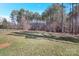 Spacious backyard with a mix of lush green grass and tree coverage provides a park-like setting at 704 Kenway Loop, Mooresville, NC 28117